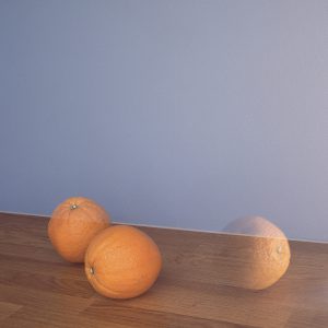 Two oranges and a reflection 